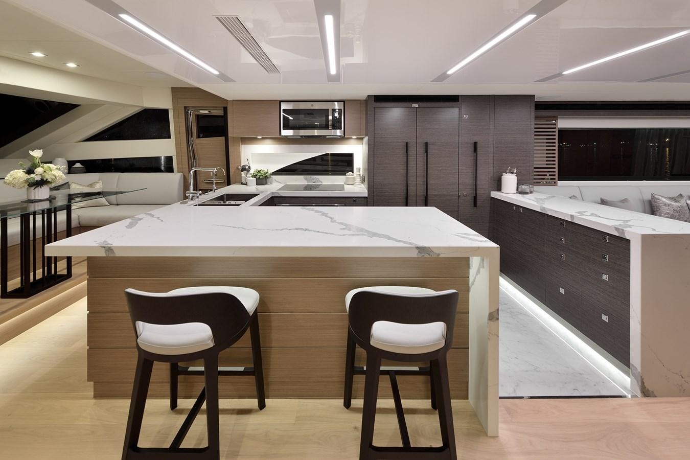 a kitchen with a large island aboard E81 Yacht for Sale