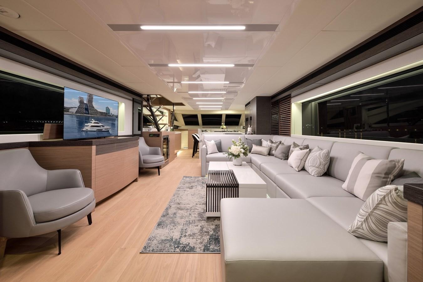 a living room with a large screen aboard E81 Yacht for Sale