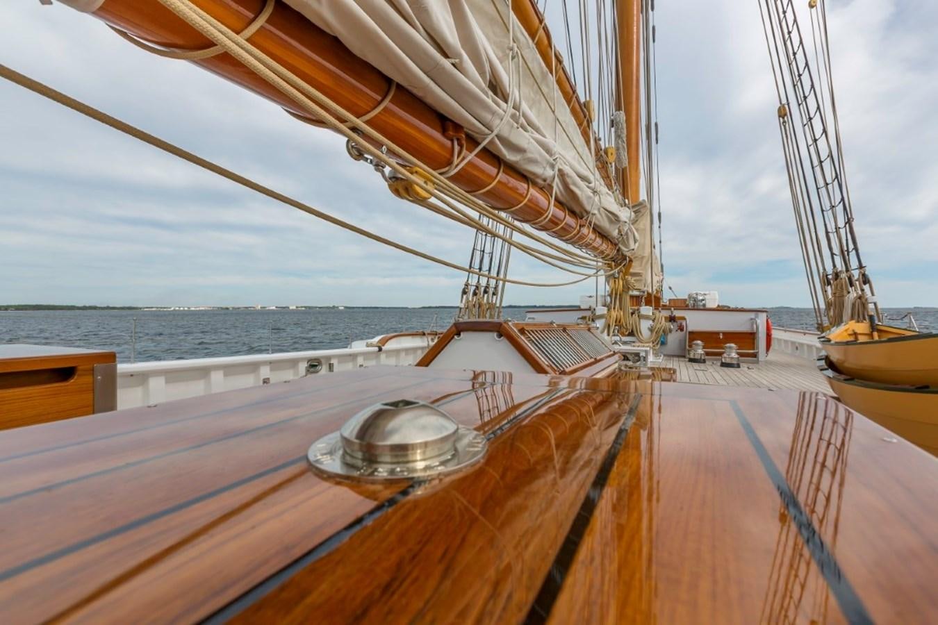 a deck with a large sailboat aboard COLUMBIA Yacht for Charter