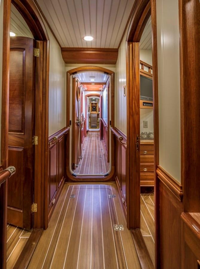 a wood walkway with doors aboard COLUMBIA Yacht for Charter
