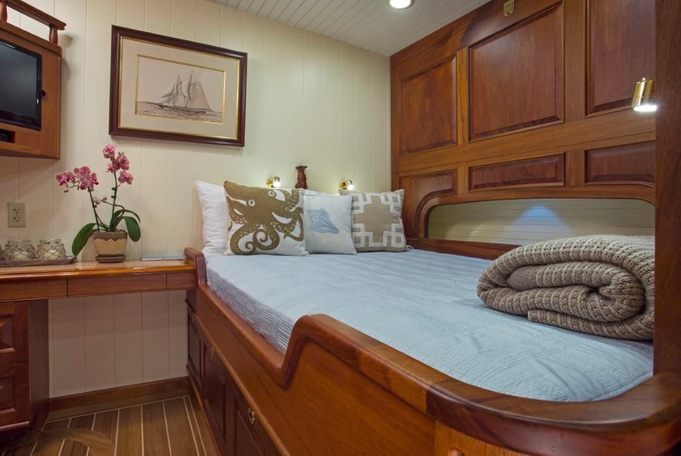 a bed with pillows and pillows aboard COLUMBIA Yacht for Charter
