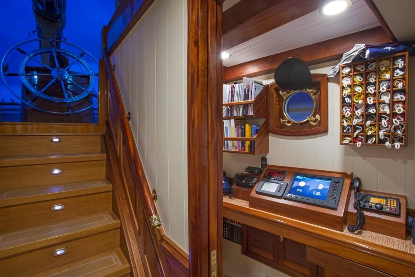 a room with a wood cabinet and a mirror on the wall aboard COLUMBIA Yacht for Charter