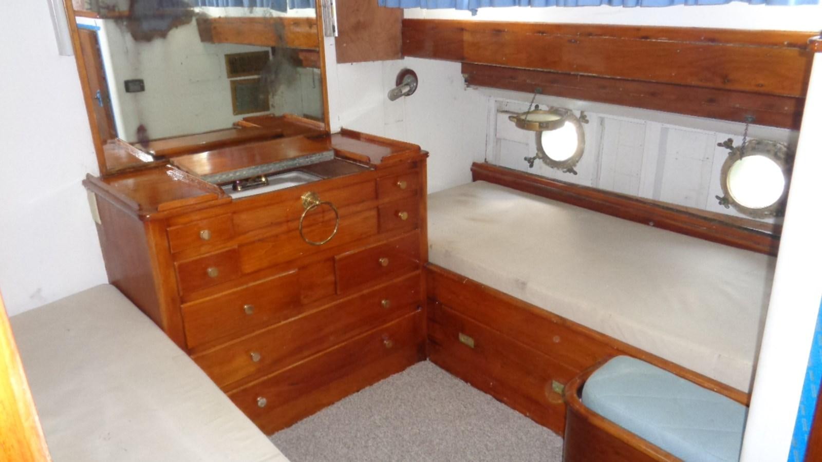 a room with a wooden cabinet and a white counter aboard LION'S WHELP Yacht for Sale