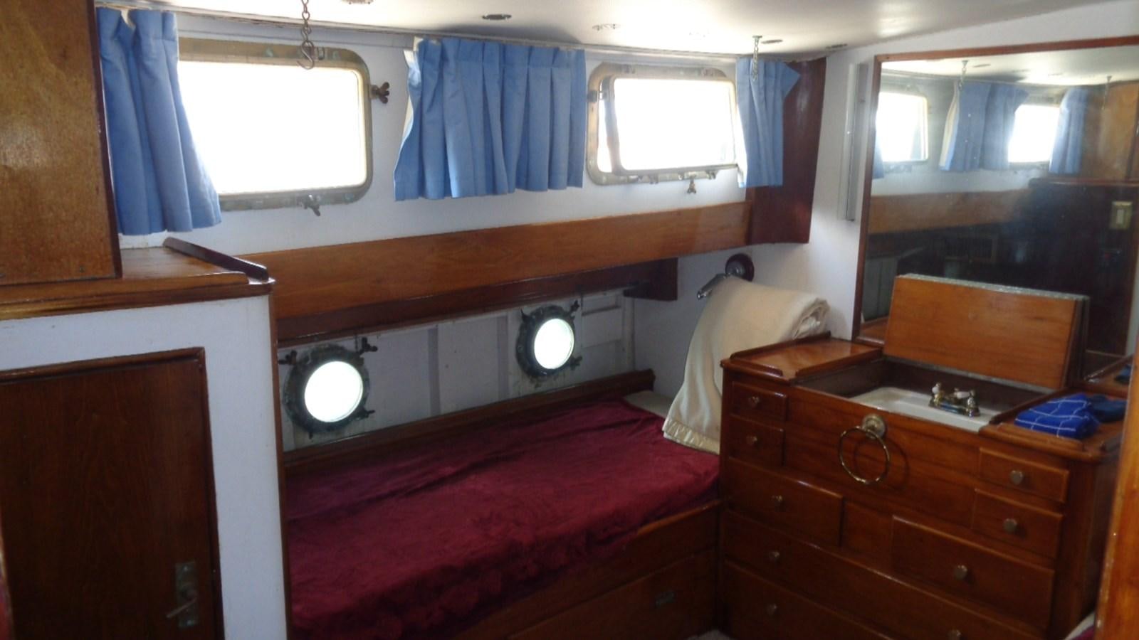 a room with a bed and a dresser aboard LION'S WHELP Yacht for Sale