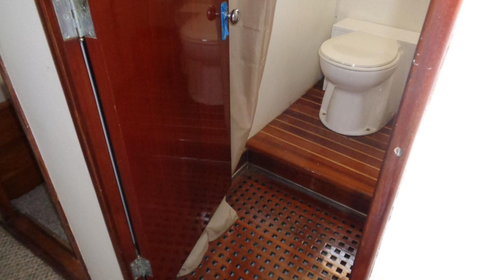 a toilet with a red door aboard LION'S WHELP Yacht for Sale
