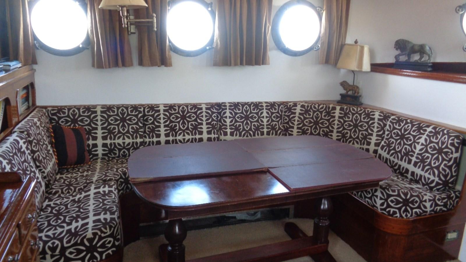 a room with a table and chairs aboard LION'S WHELP Yacht for Sale