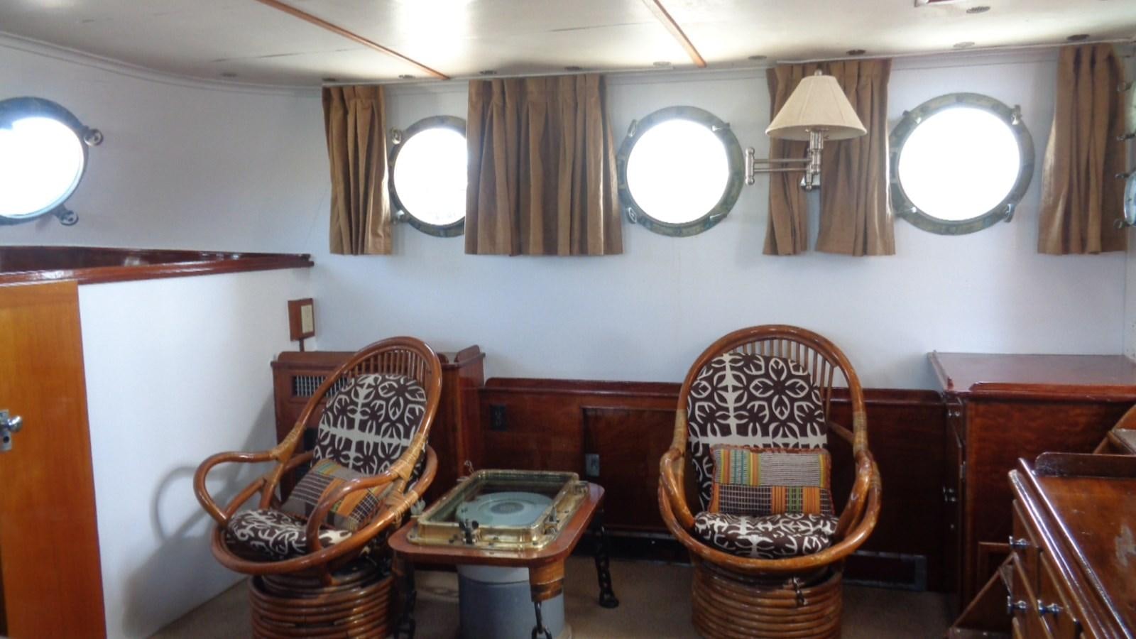 a room with chairs and a mirror aboard LION'S WHELP Yacht for Sale