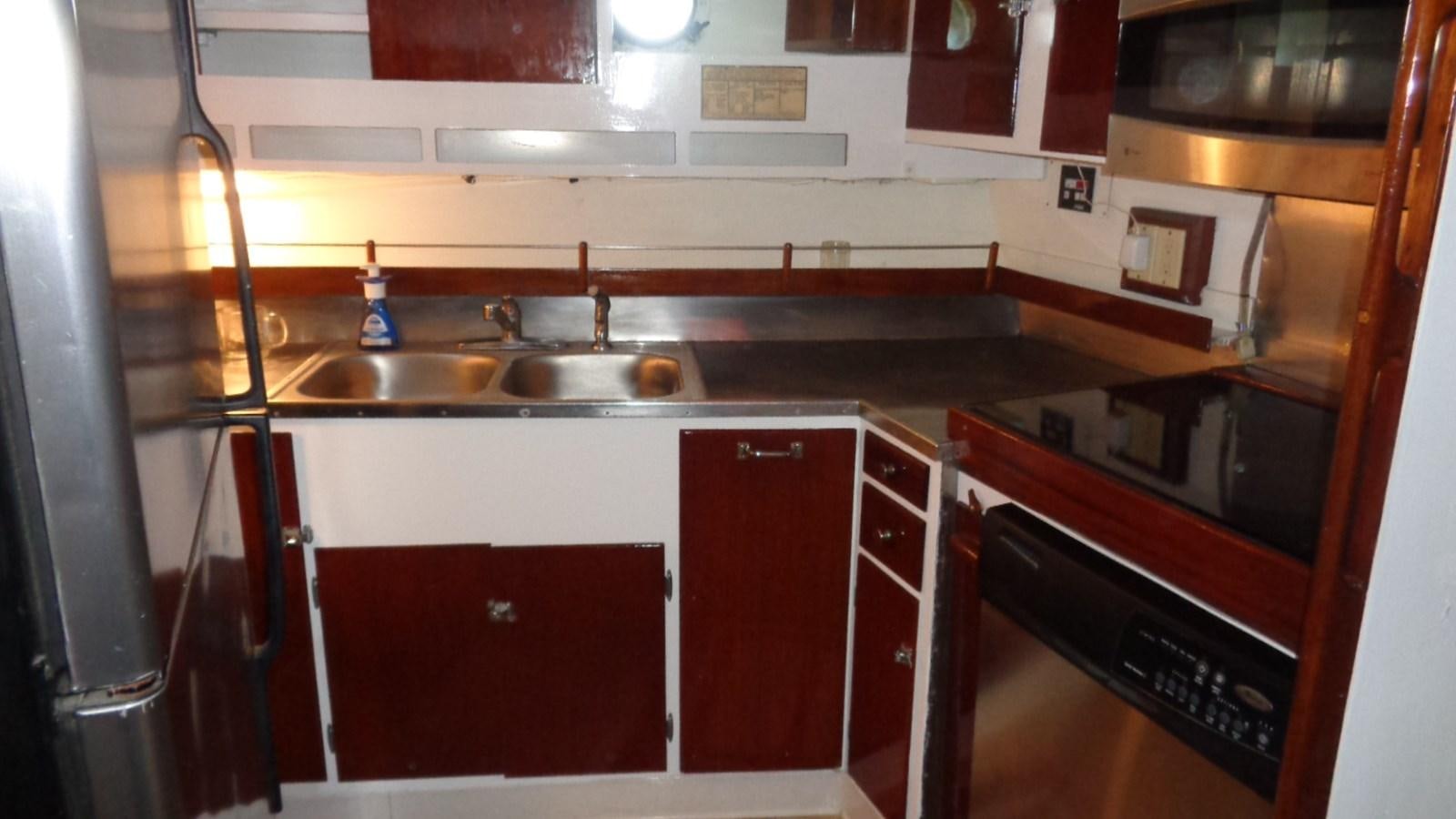 a kitchen with red cabinets aboard LION'S WHELP Yacht for Sale