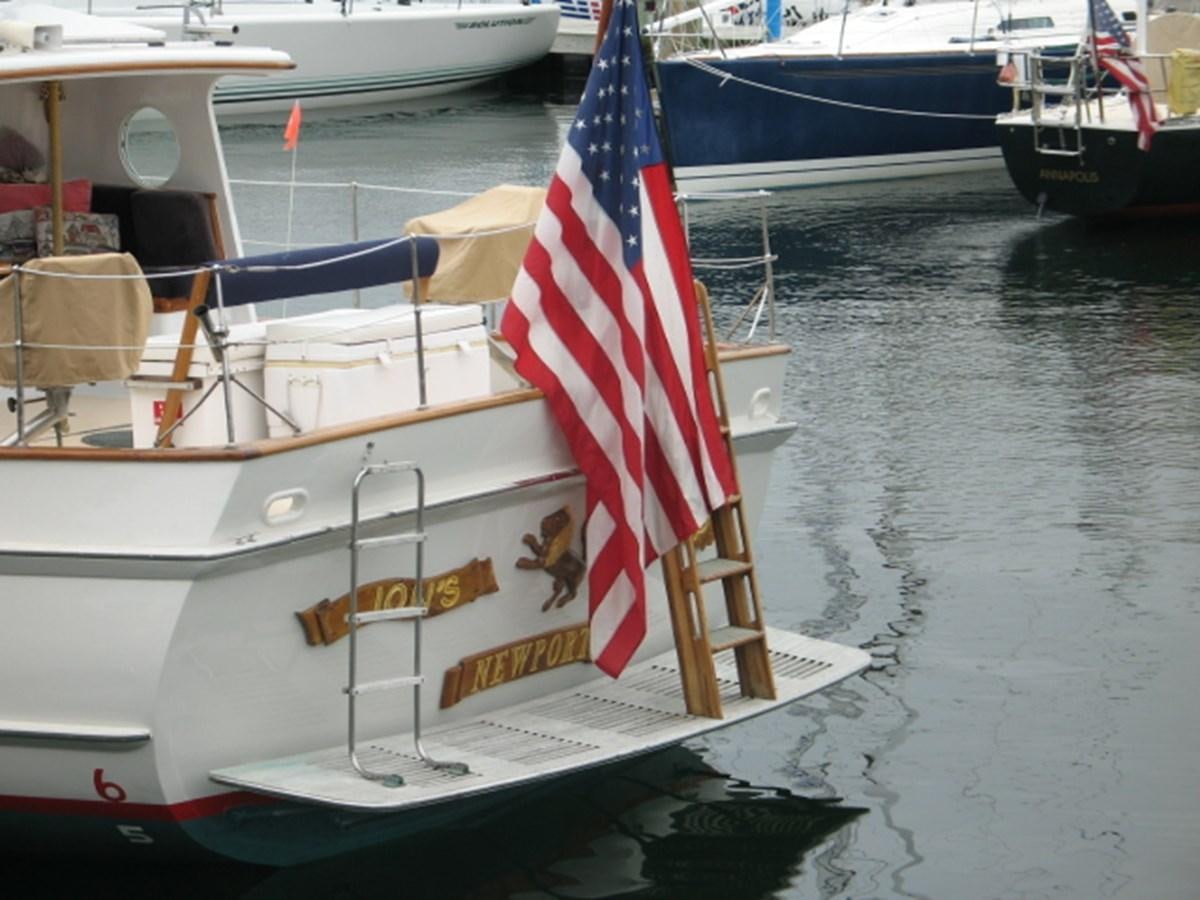 a boat with a flag on it aboard LION'S WHELP Yacht for Sale