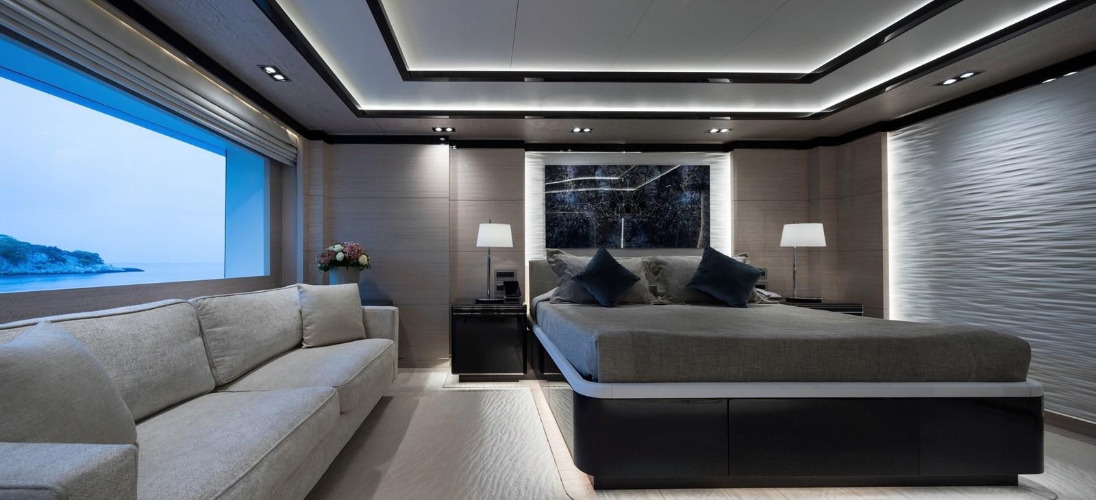 a large room with a bed and a couch aboard O'PTASIA Yacht for Charter