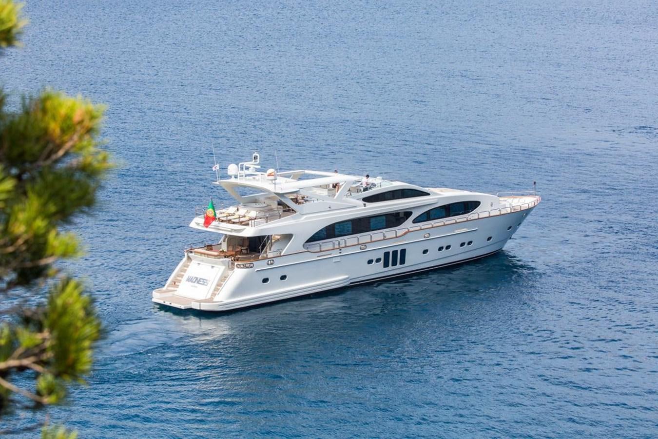 a white yacht in the water aboard MADNESS Yacht for Sale