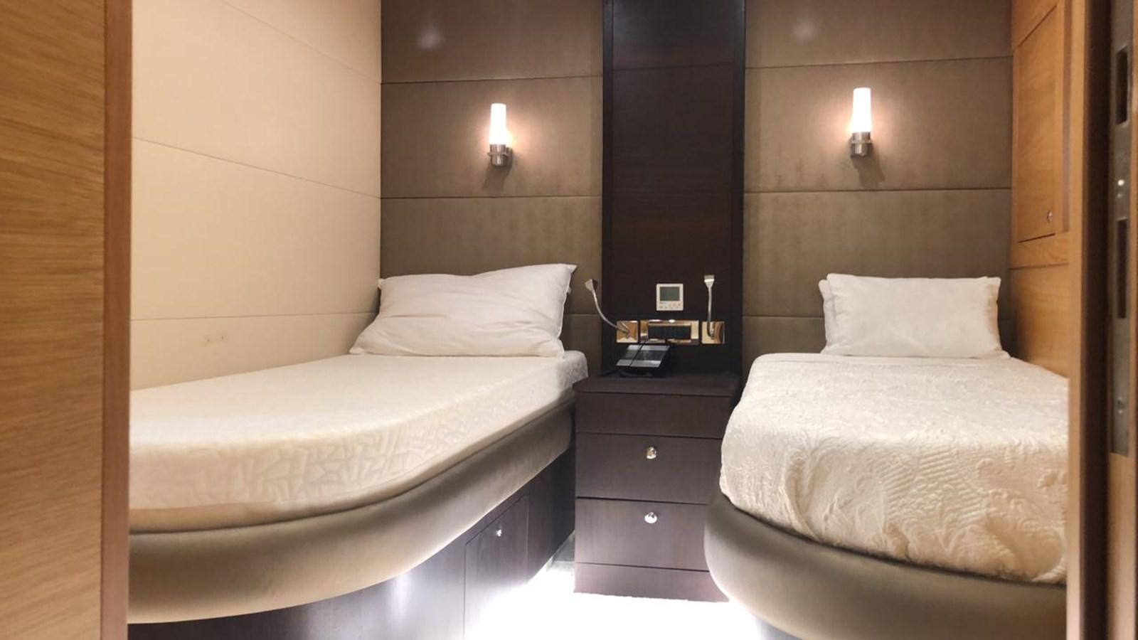 a couple of beds in a room aboard MADNESS Yacht for Sale