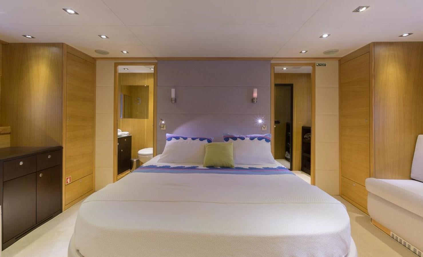 a large bed in a hotel room aboard MADNESS Yacht for Sale