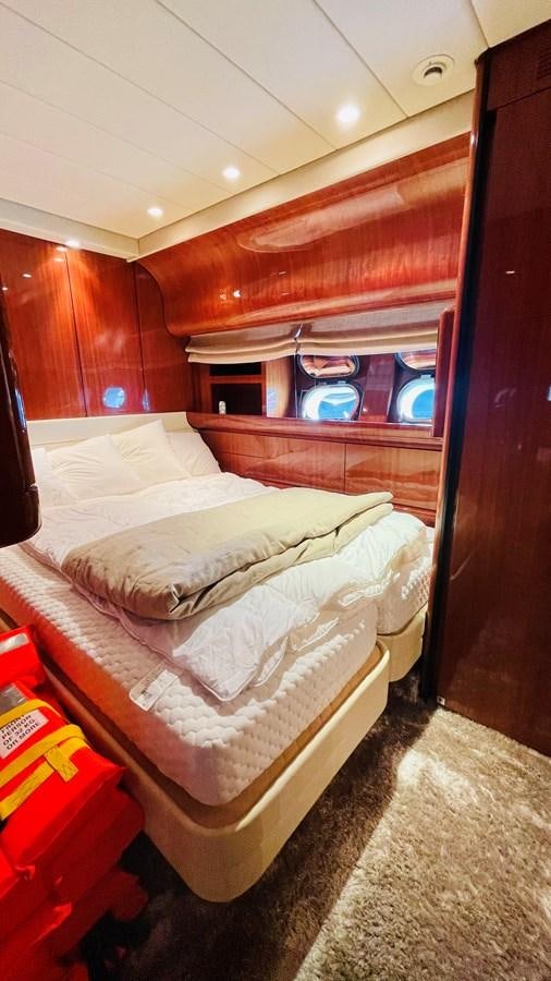 a room with a bed and a mirror aboard NOTORIOUS Yacht for Sale