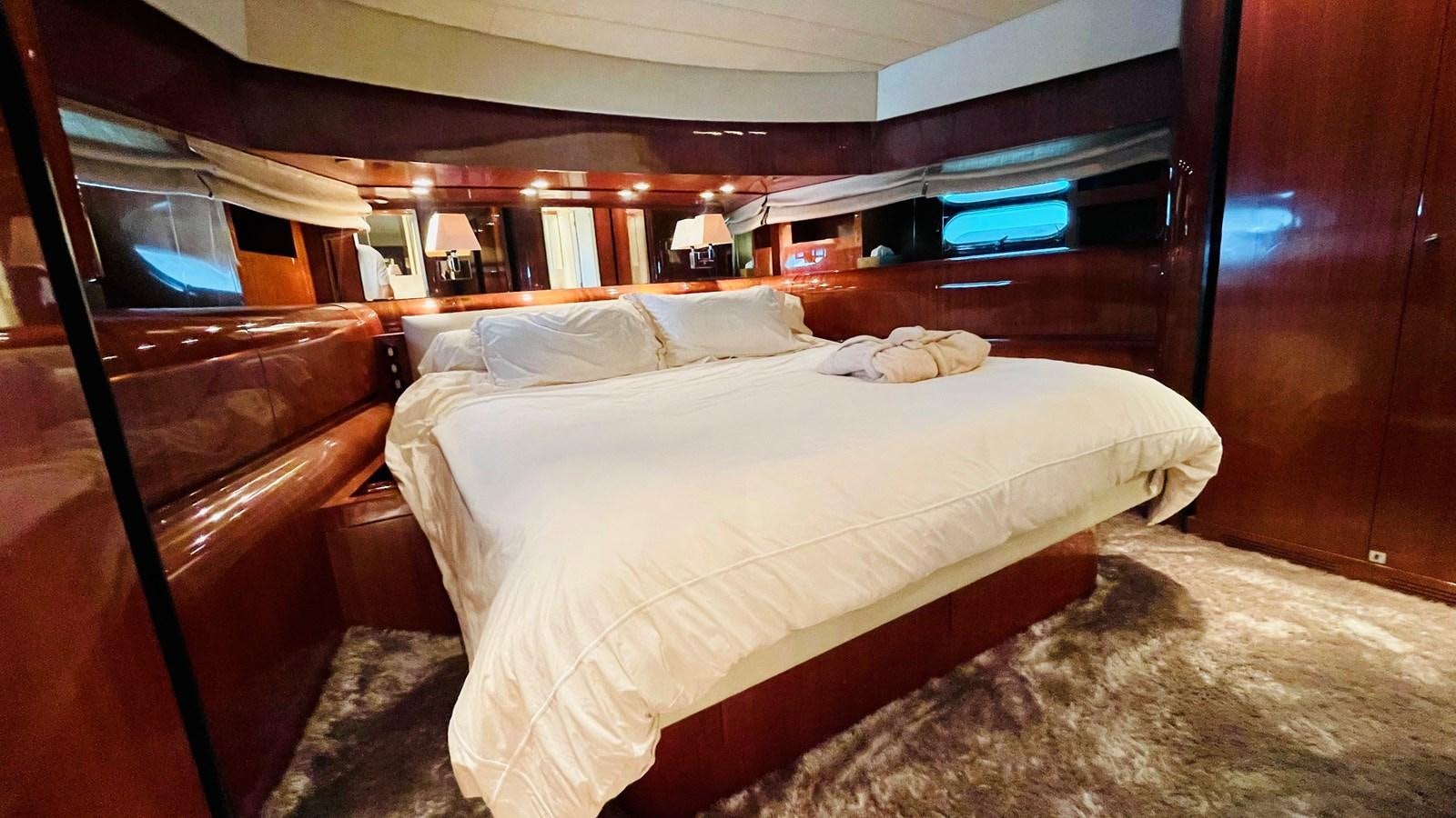 a room with a bed and a television aboard NOTORIOUS Yacht for Sale