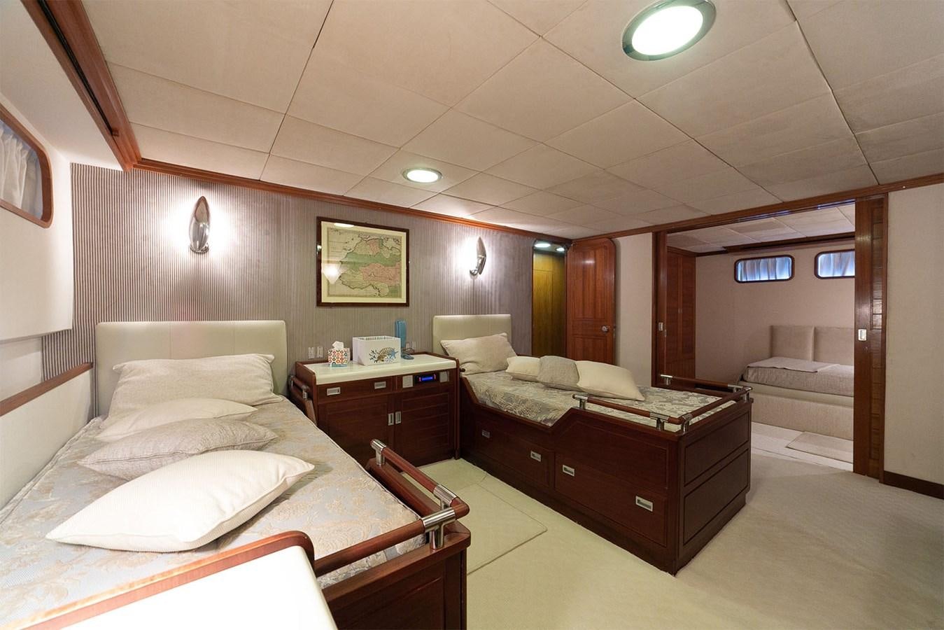a hotel room with a bed and desk aboard EMERA Yacht for Sale