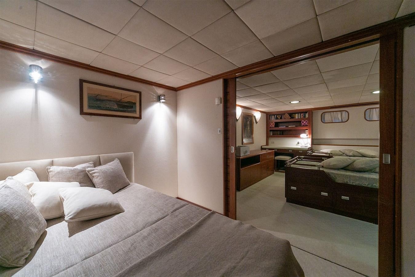 a room with a bed and a mirror aboard EMERA Yacht for Sale