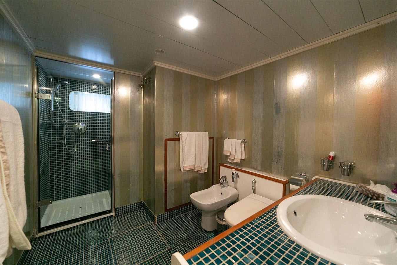 a bathroom with a glass shower aboard EMERA Yacht for Sale