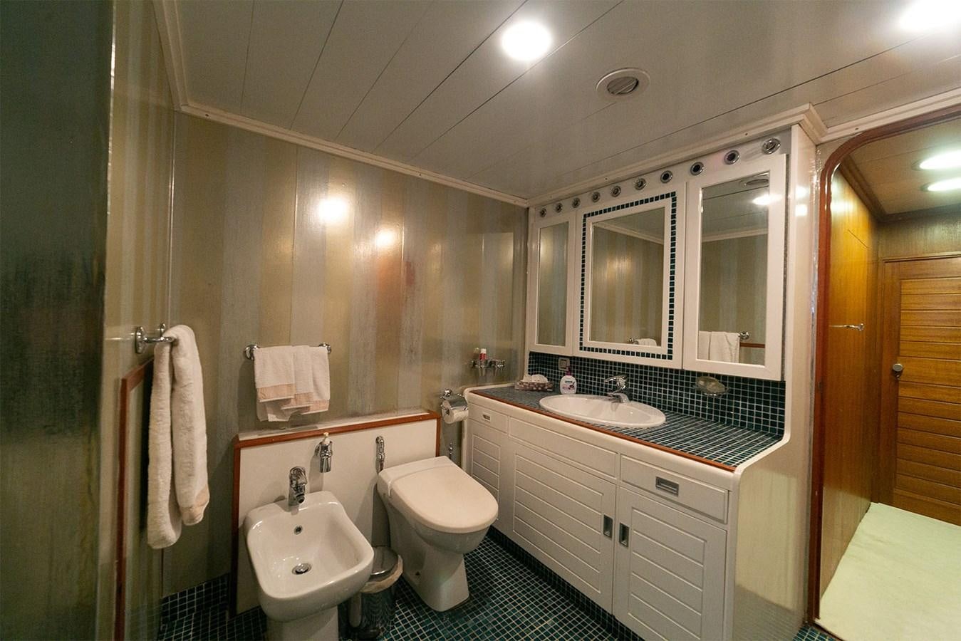 a bathroom with a sink toilet and a mirror aboard EMERA Yacht for Sale