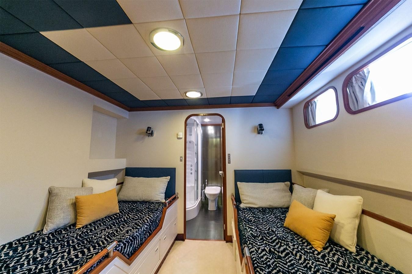 a room with a bed and a couch aboard EMERA Yacht for Sale