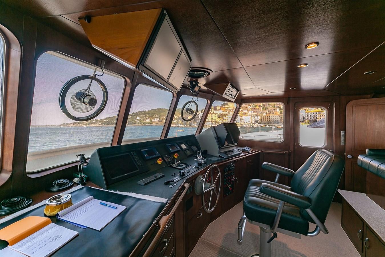 a room with a table chairs and a large window aboard EMERA Yacht for Sale