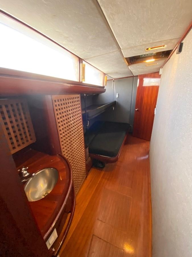 a small kitchen with a wood table aboard LAUREN L Yacht for Sale