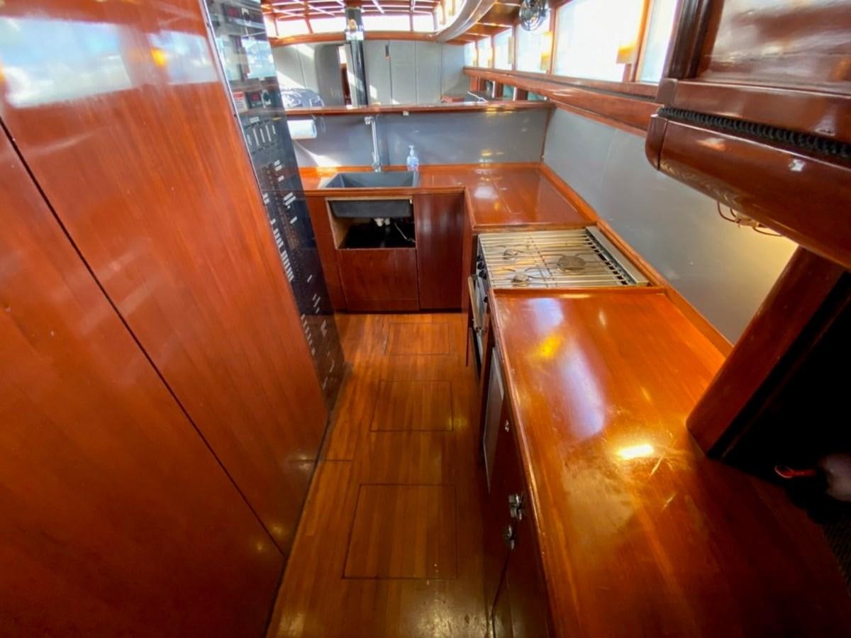 a kitchen with a large wooden counter aboard LAUREN L Yacht for Sale