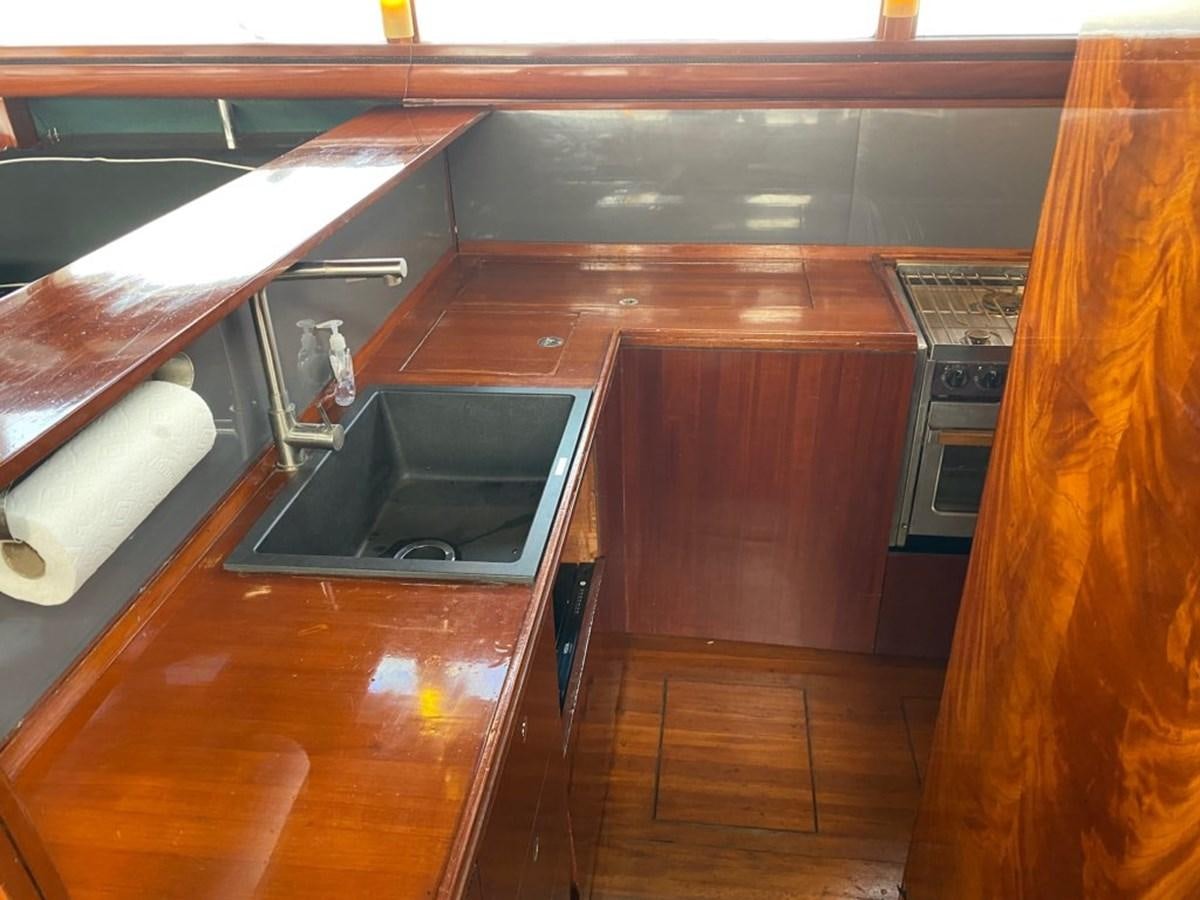 a kitchen with a wood floor aboard LAUREN L Yacht for Sale