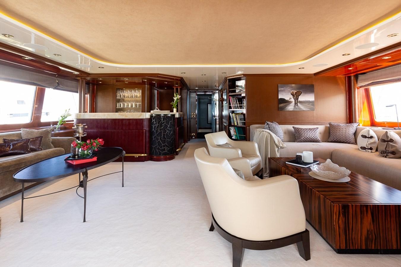 a living room with a table and couches aboard IL SOLE Yacht for Sale