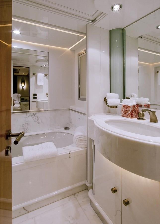 a bathroom with a tub sink and mirror aboard IL SOLE Yacht for Sale