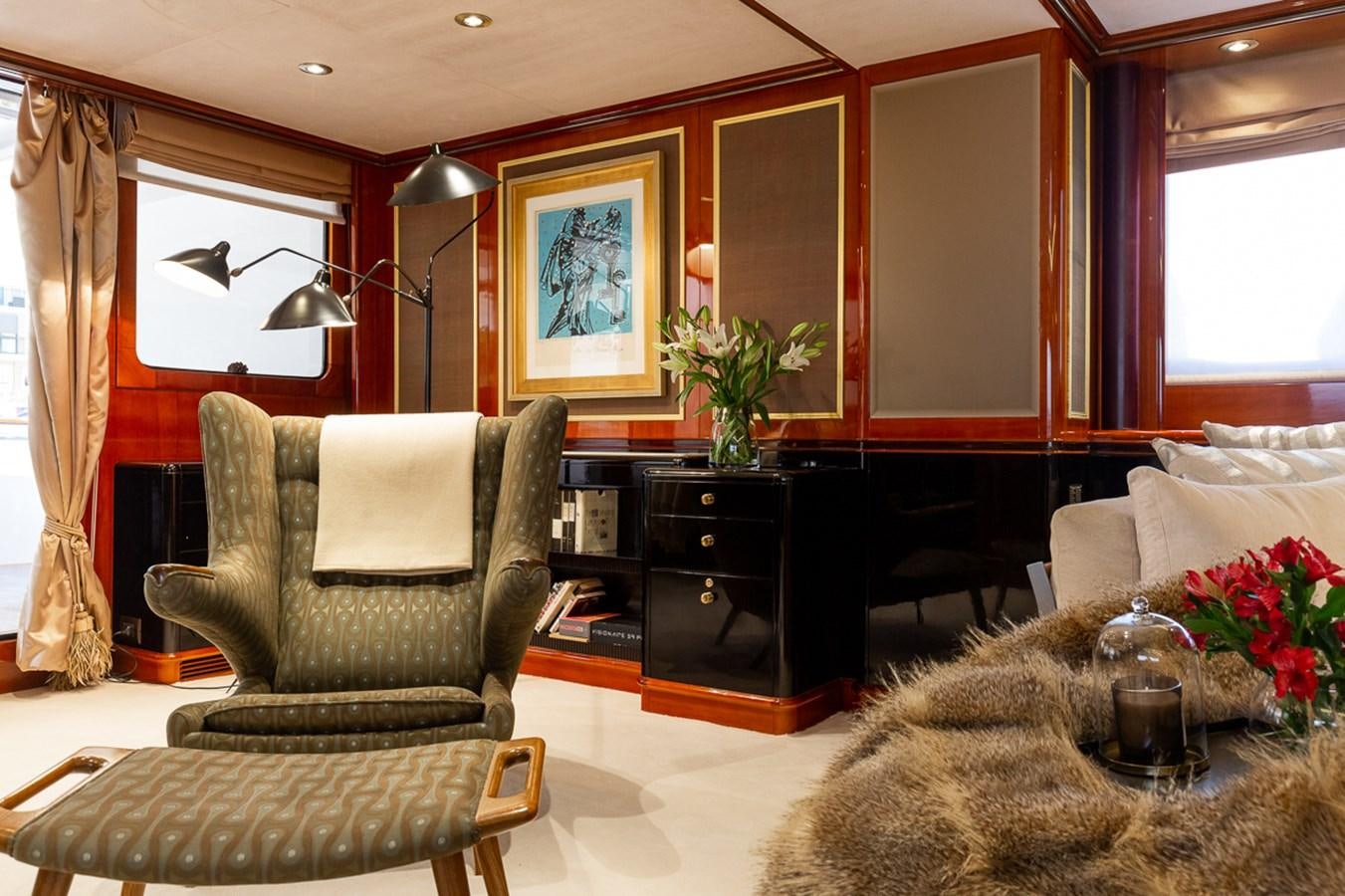 a living room with a chair and a table aboard IL SOLE Yacht for Sale