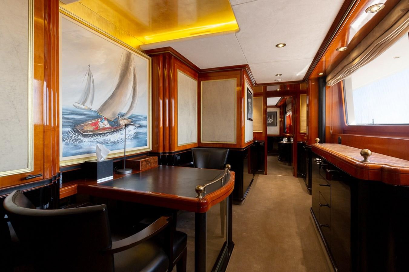 a room with a table and chairs aboard IL SOLE Yacht for Sale