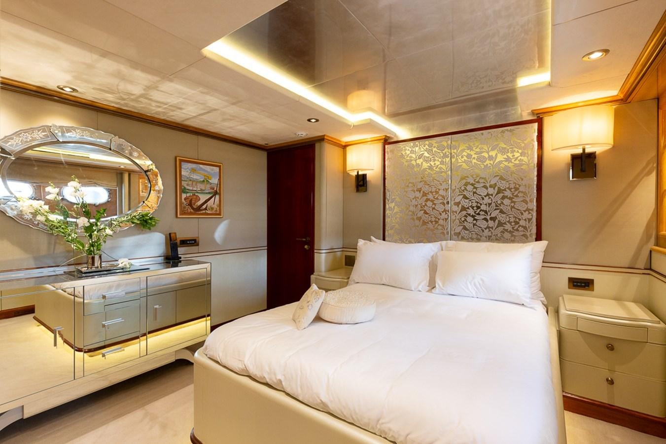 a bedroom with a large mirror aboard IL SOLE Yacht for Sale