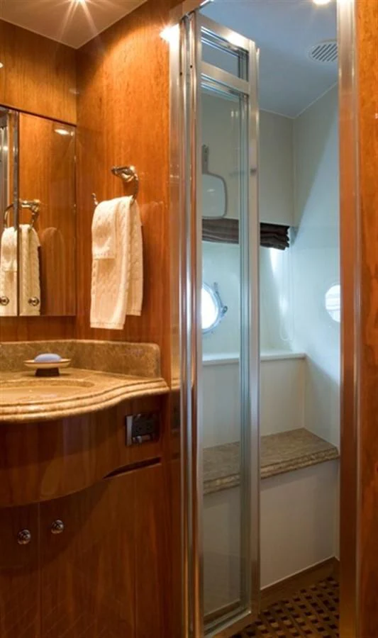 a bathroom with a glass shower aboard SEA LEGEND Yacht for Sale