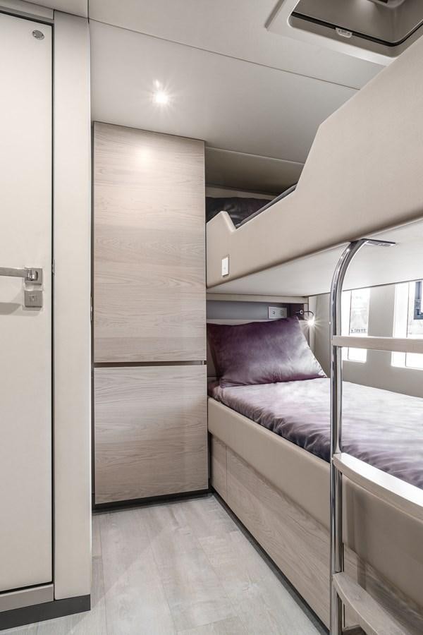 a room with a bed and a window aboard GIJA Yacht for Sale