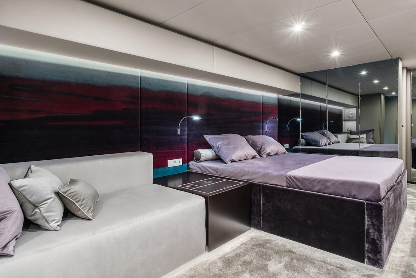 a room with a bed and a couch aboard GIJA Yacht for Sale