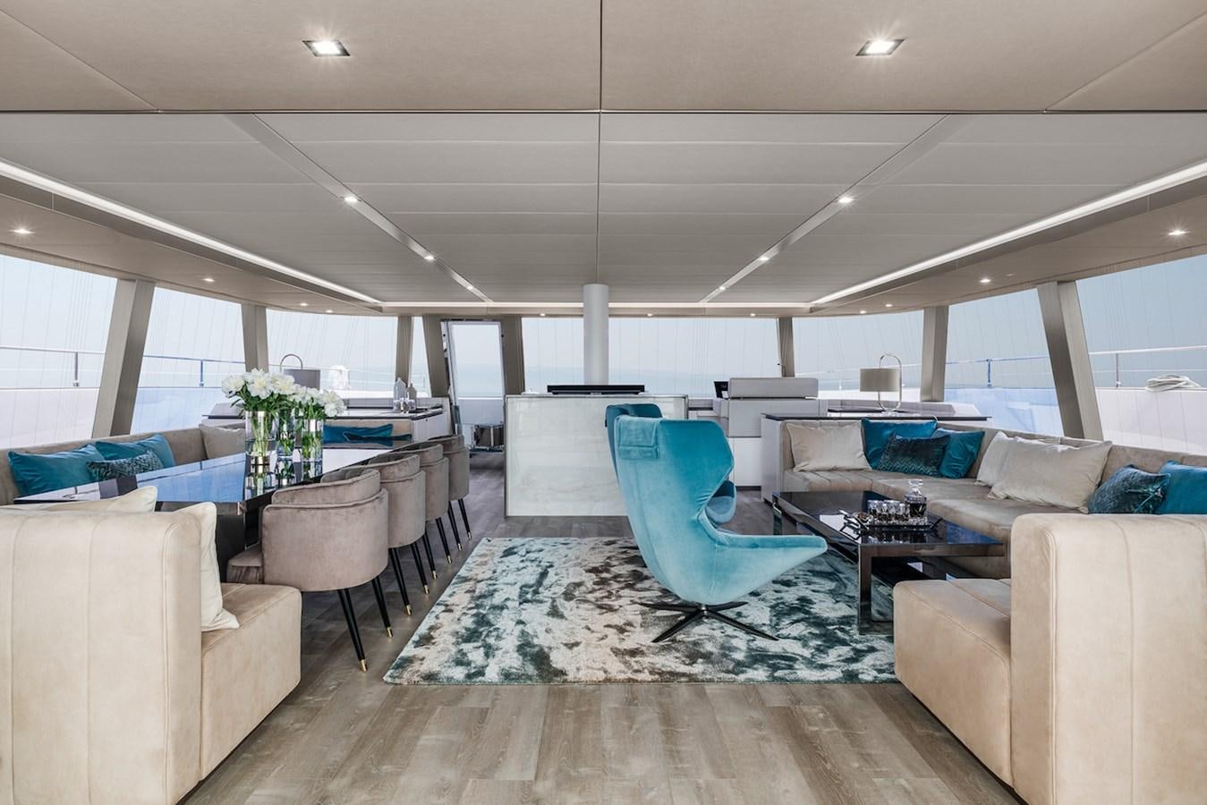 a room with a large blue chair aboard GIJA Yacht for Sale