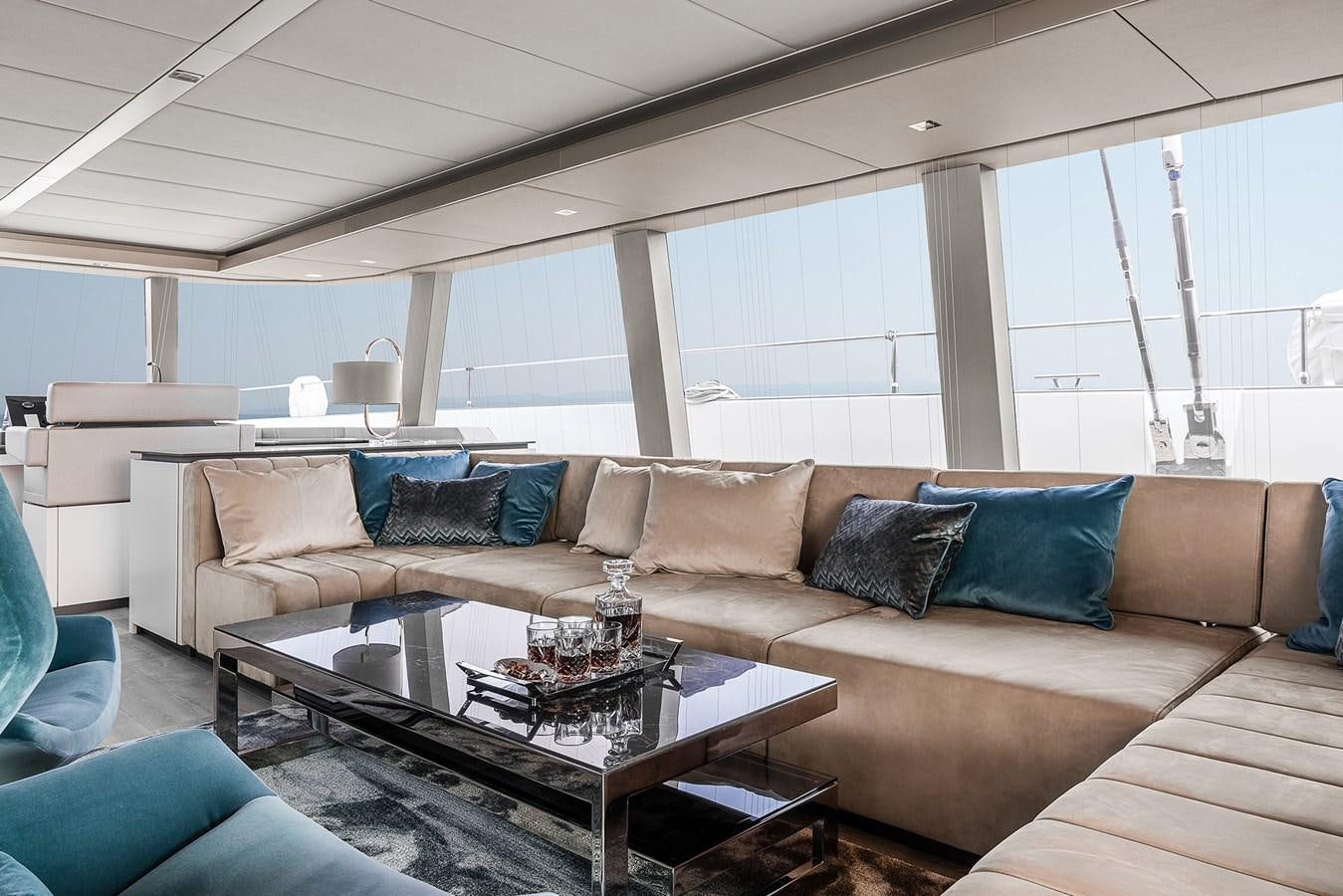 a living room with a couch and a coffee table aboard GIJA Yacht for Sale