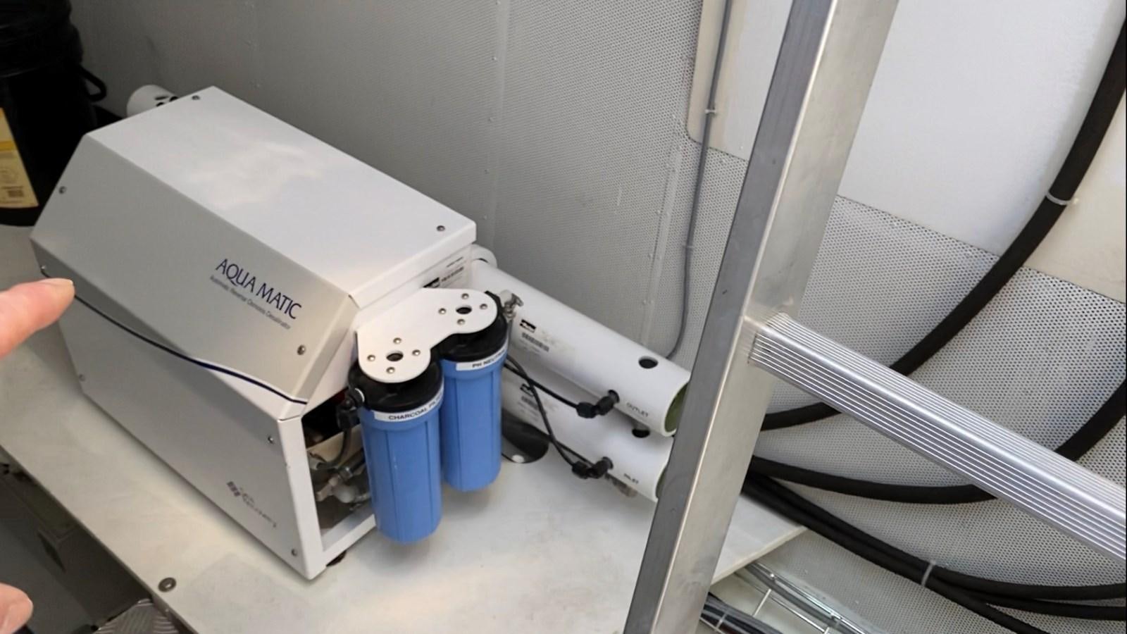 a hand holding a white machine aboard GIJA Yacht for Sale