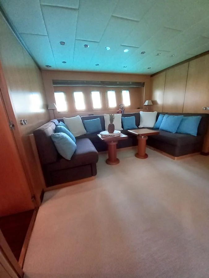 a room with a couch and a table aboard BRAVO DELTA Yacht for Sale