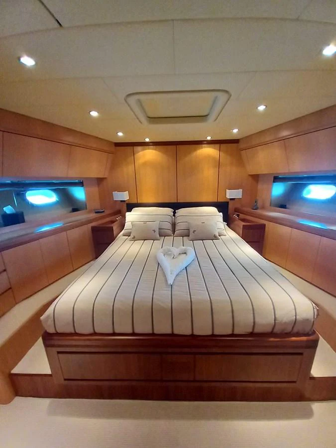 a room with a bed and a television aboard BRAVO DELTA Yacht for Sale