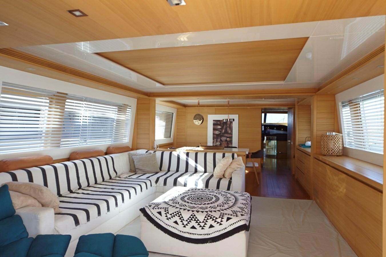 a living room with a couch and a table aboard GULU Yacht for Sale