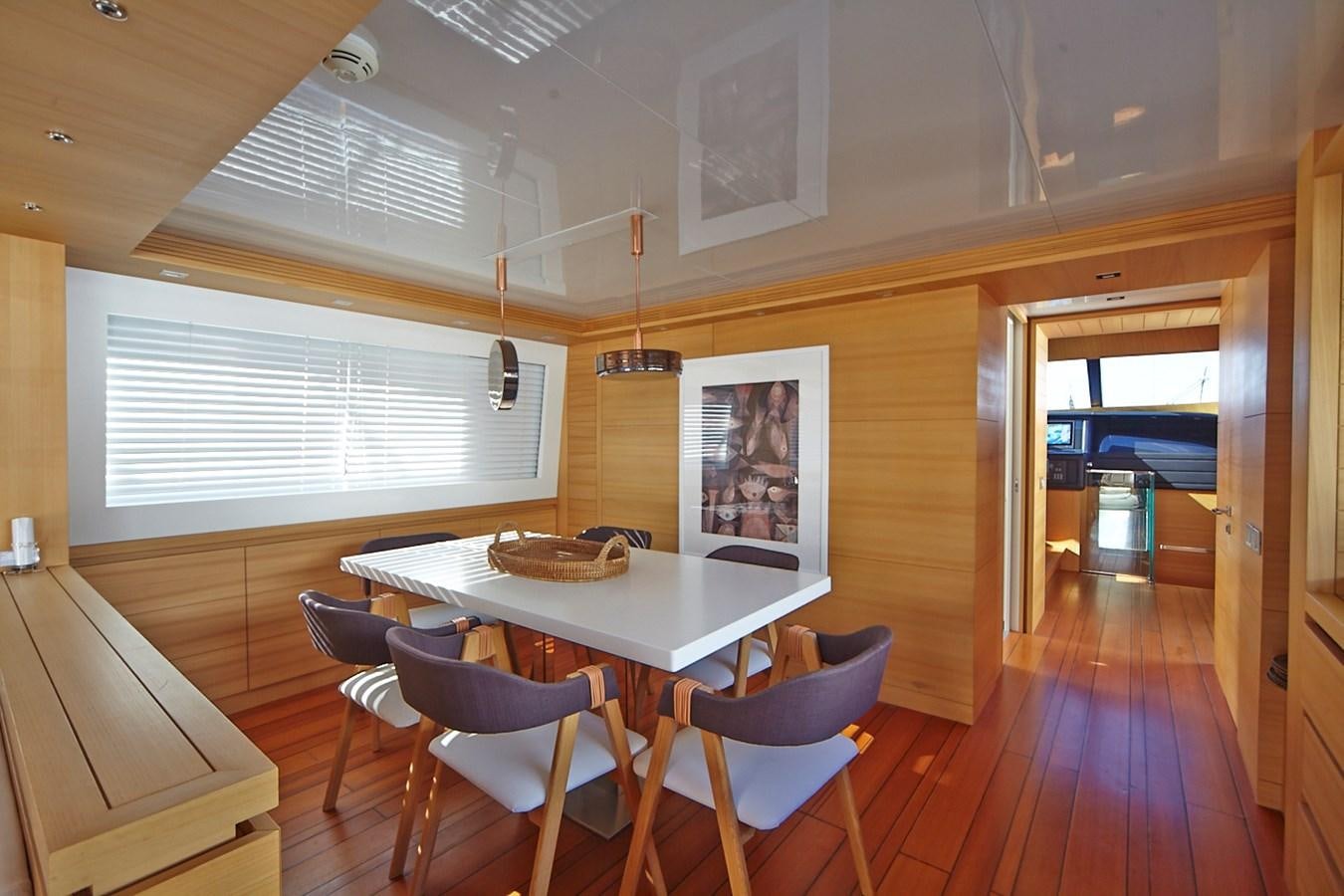 a room with a table and chairs aboard GULU Yacht for Sale