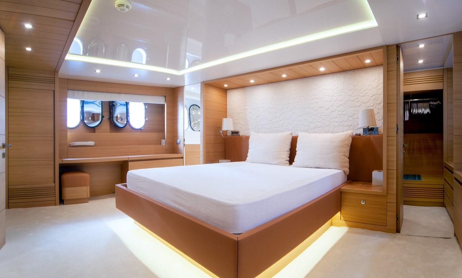 a room with a bed and a mirror aboard GULU Yacht for Sale