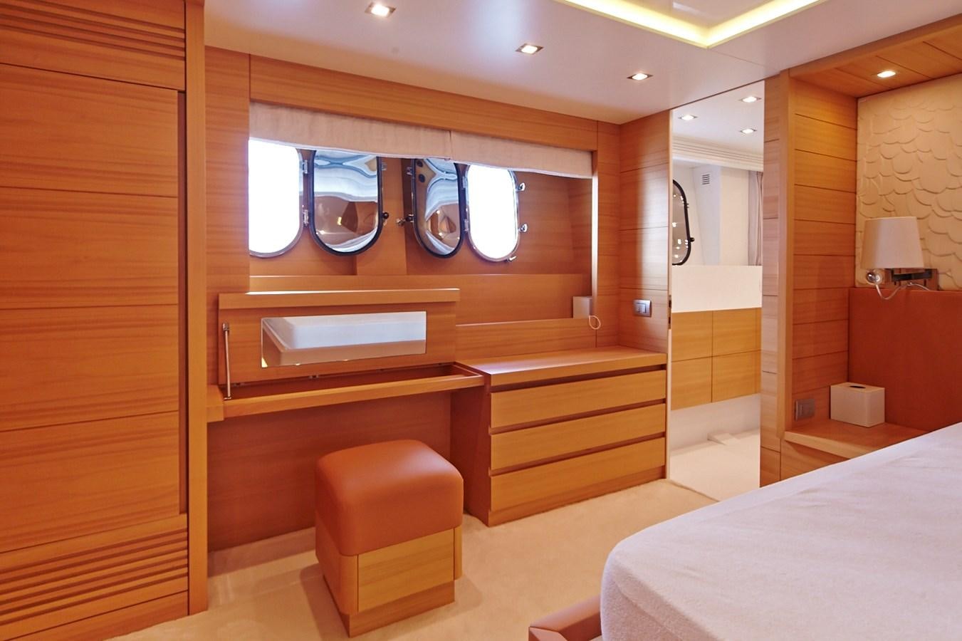 a room with a bed and a mirror aboard GULU Yacht for Sale