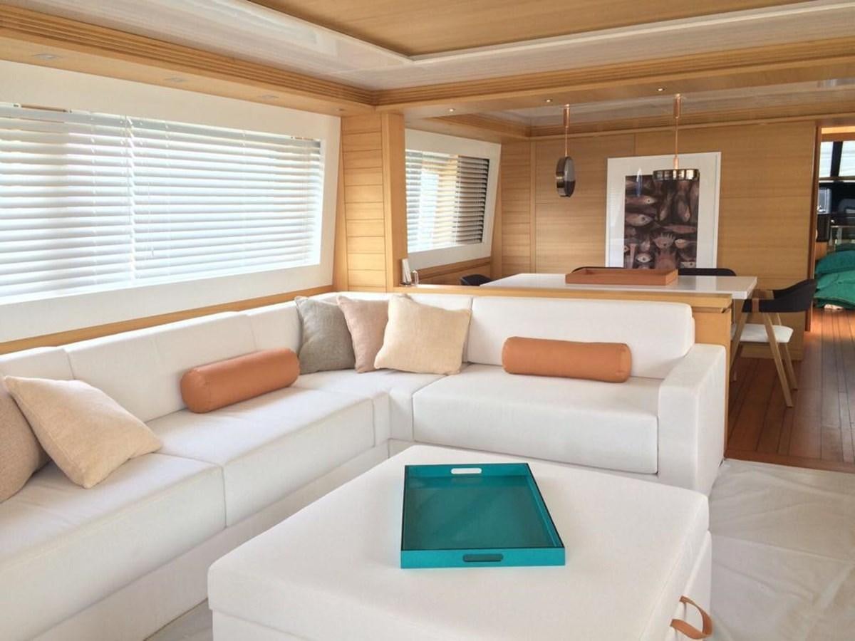 a living room with a couch and a table aboard GULU Yacht for Sale