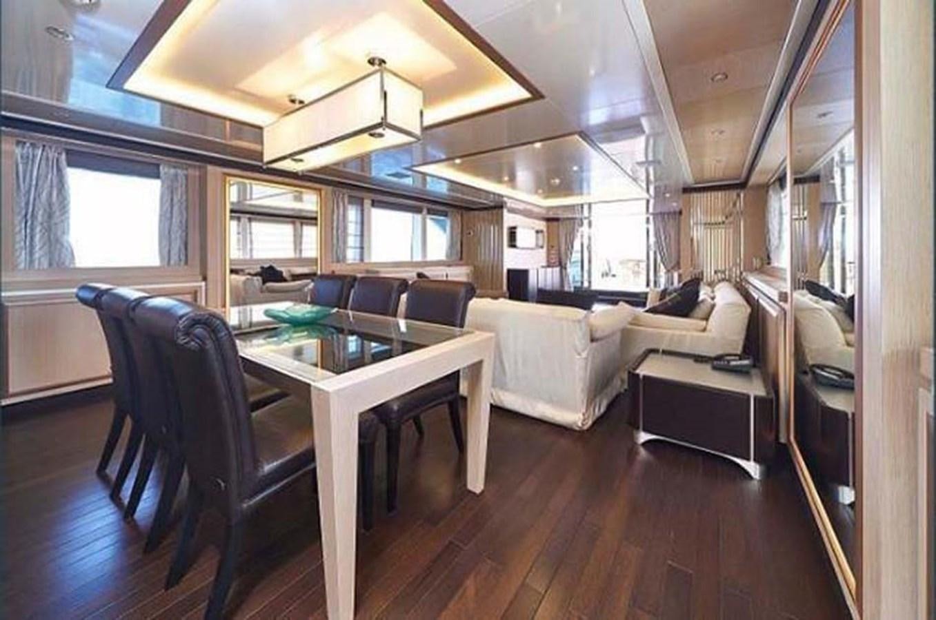 a living room with a table and chairs aboard BLUE BERRY Yacht for Sale