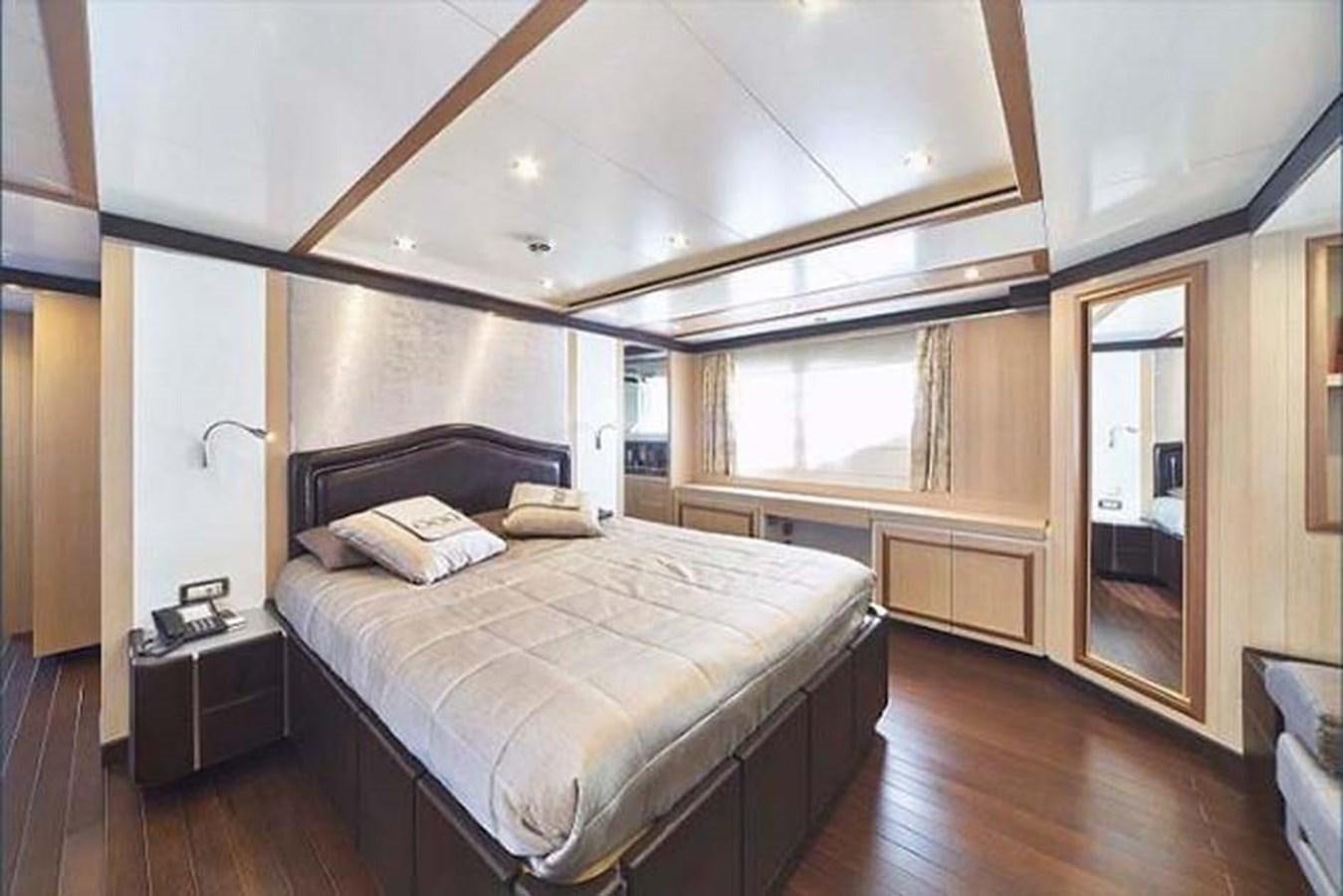 a bedroom with a bed and a wood floor aboard BLUE BERRY Yacht for Sale