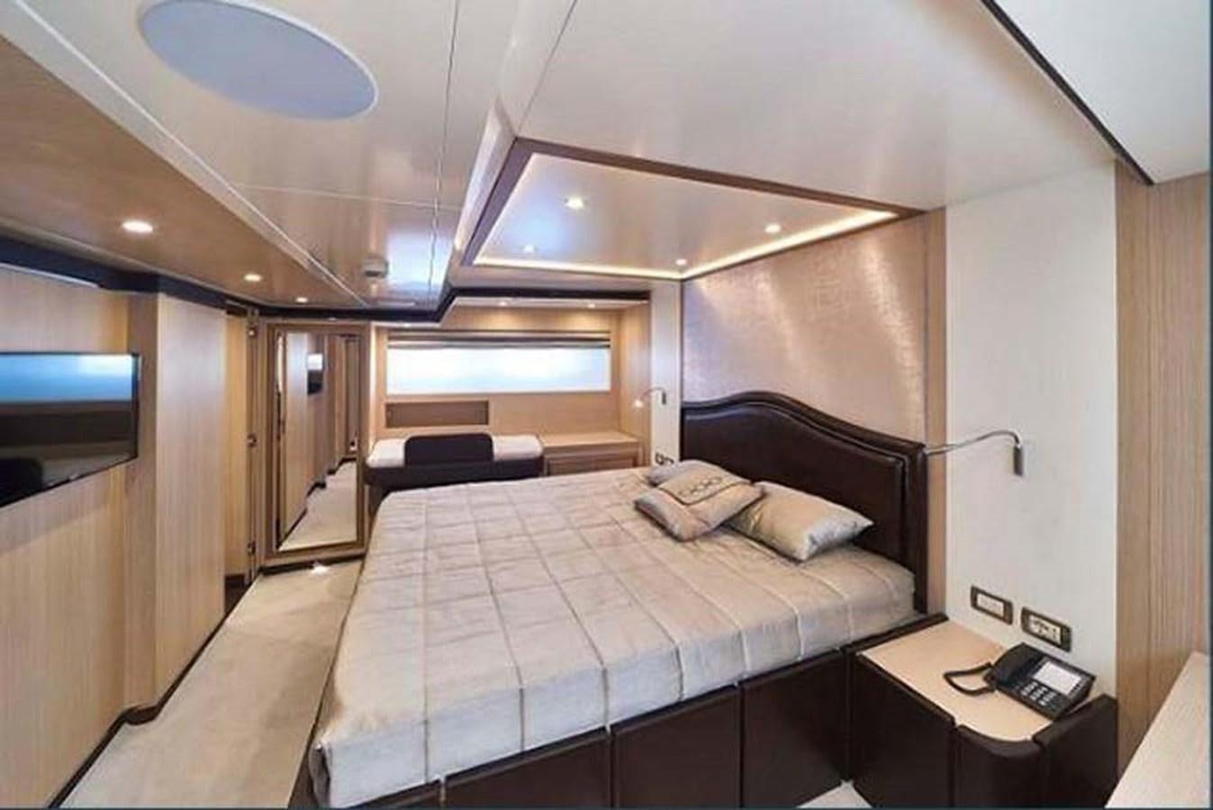 a room with a bed and a desk aboard BLUE BERRY Yacht for Sale