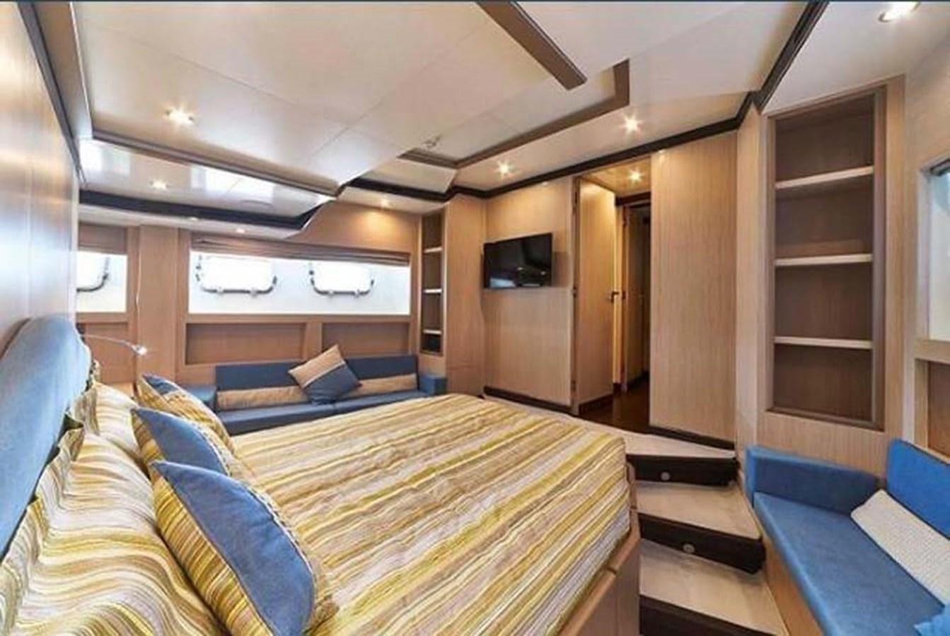 a bedroom with a bed and a television aboard BLUE BERRY Yacht for Sale